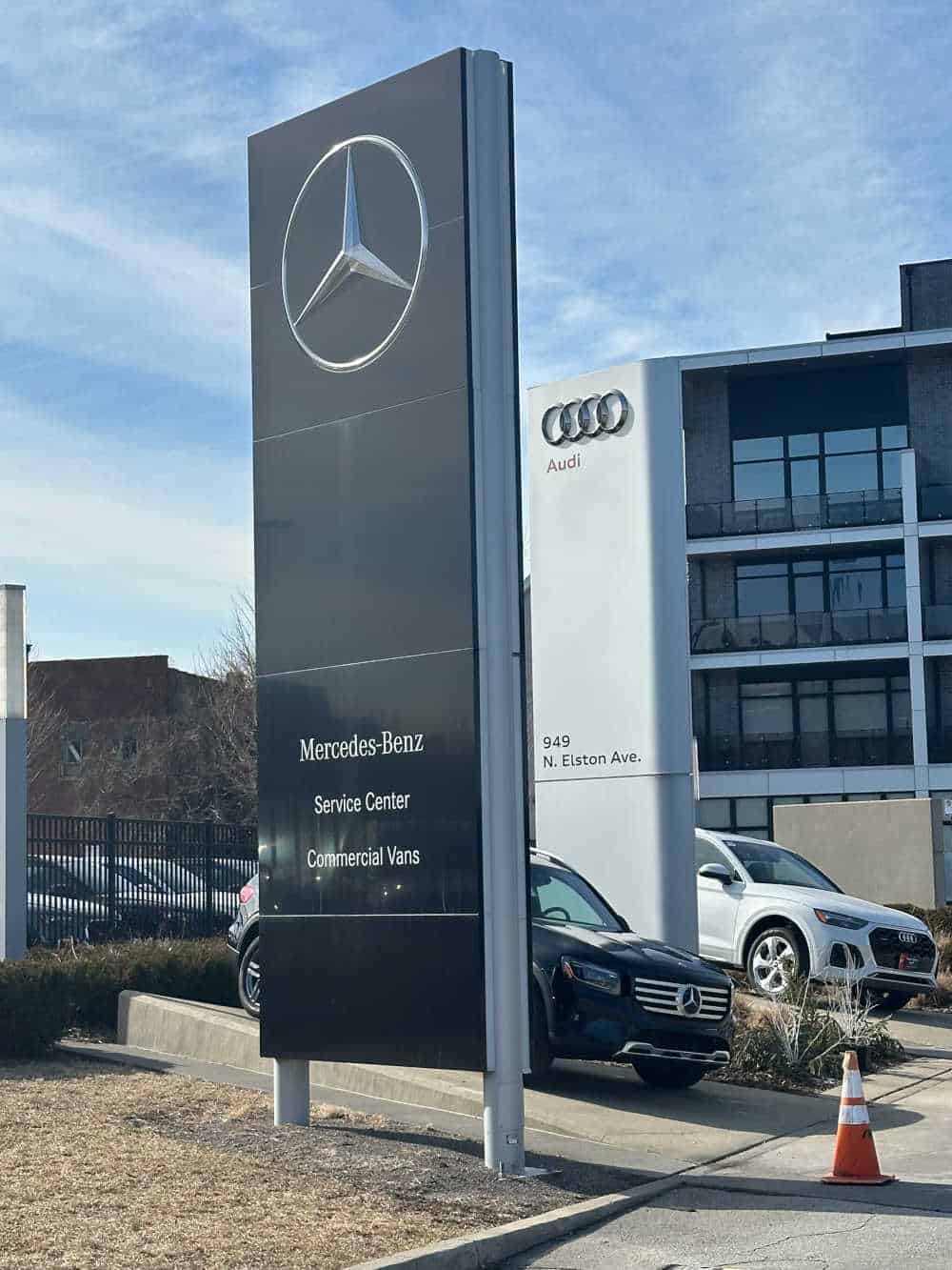 Large signage in front of a Mercedes-Benz Service Center and Commercial Vans division, with Audi dealership visible in the background on Elston Avenue in Chicago.
