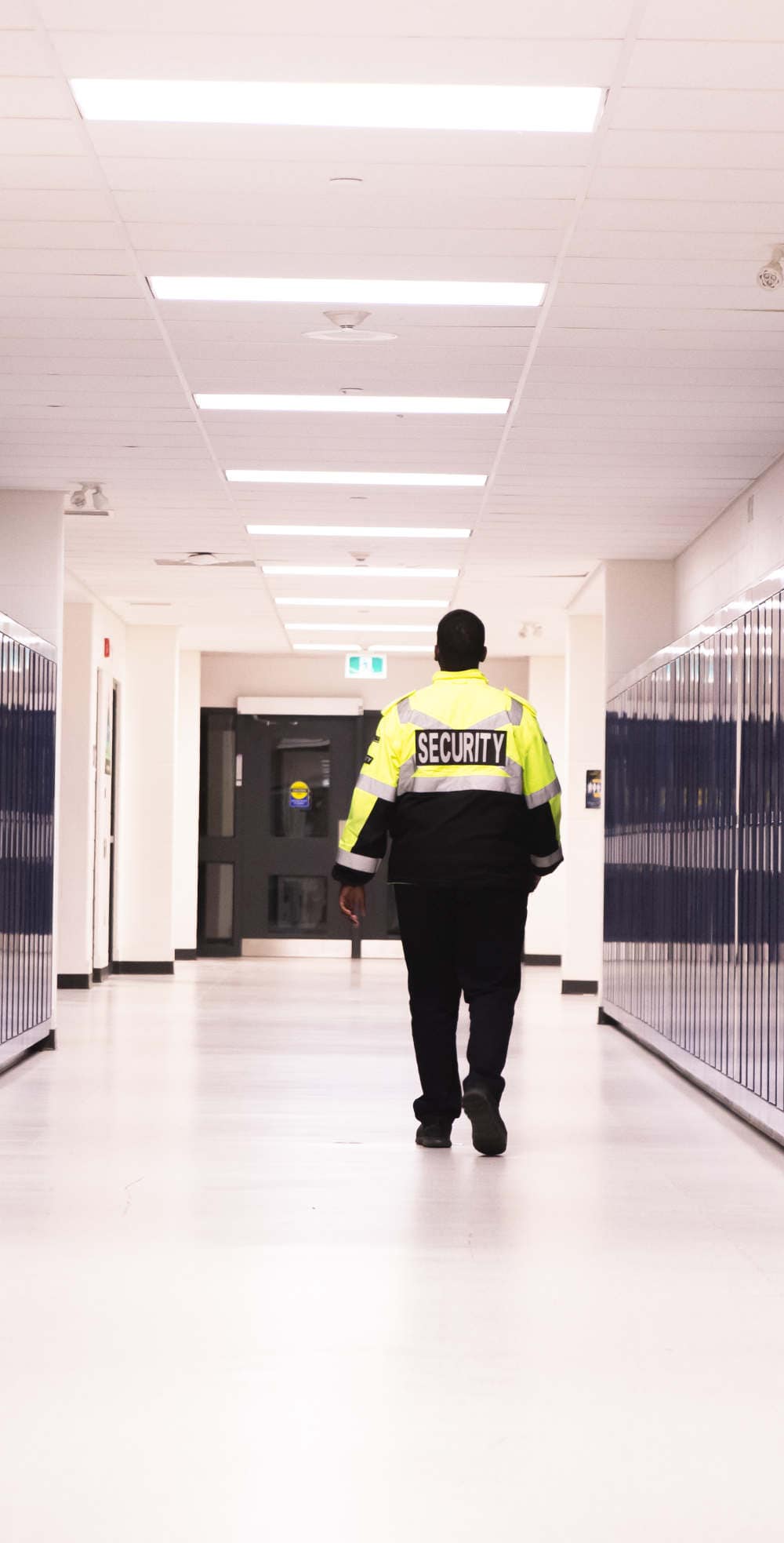 School Security Guard Patrolling Hallway School Security Guard Patrolling Hallway