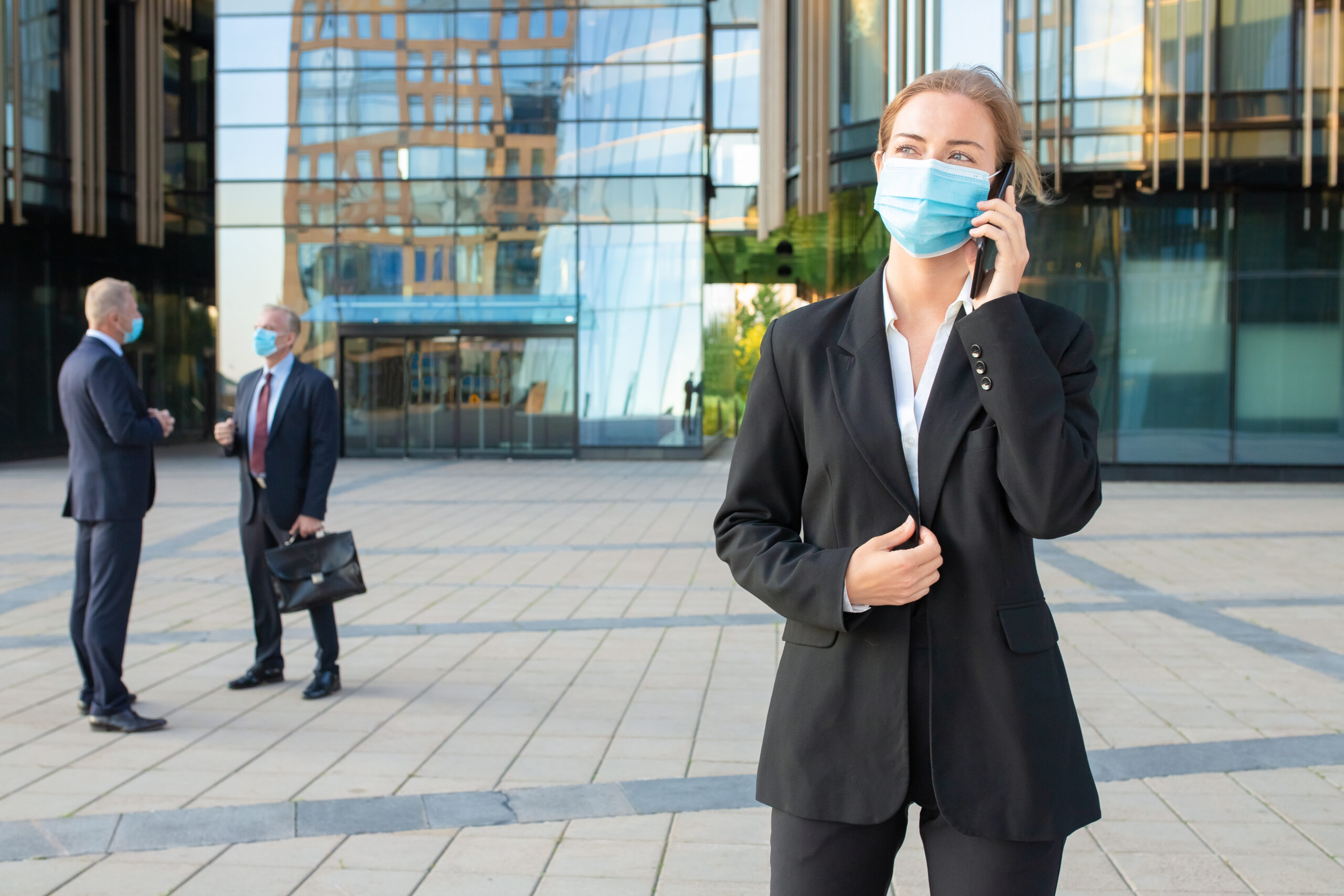 Young businesswoman wearing mask and office suit
